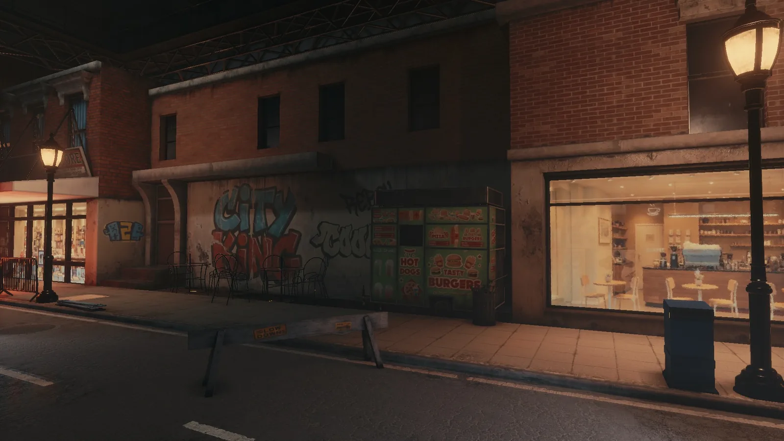 BLACKWOOD street at night, with graffiti on a shuttered wall, street lamps and a lit shop window