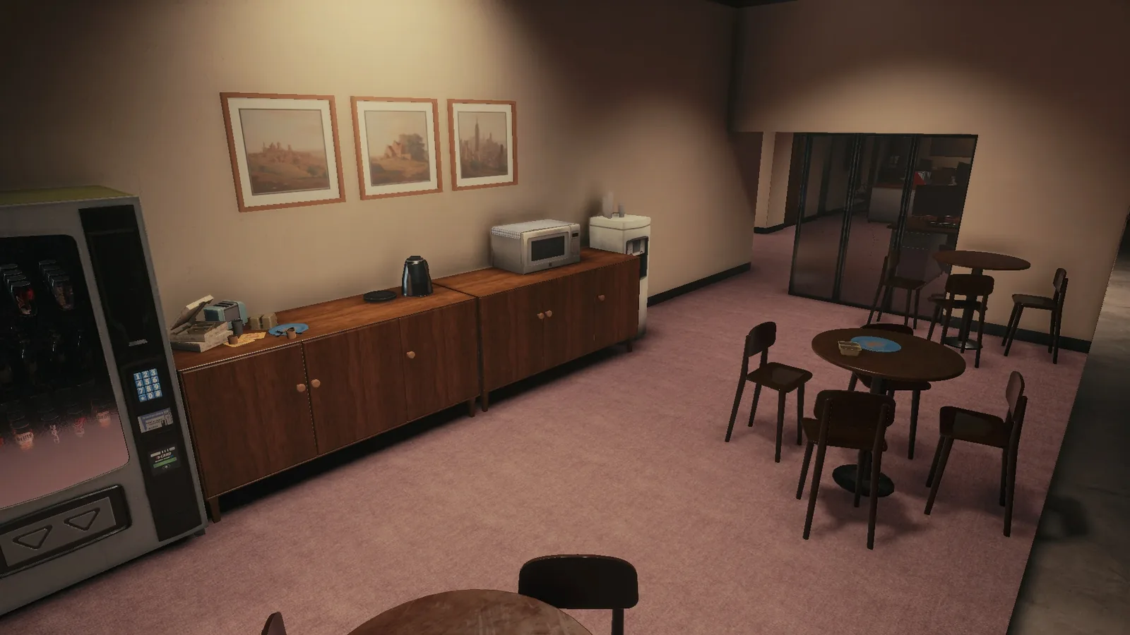 Break room on the BLACKWOOD office set, with a vending machine, round tables, a microwave and framed prints
