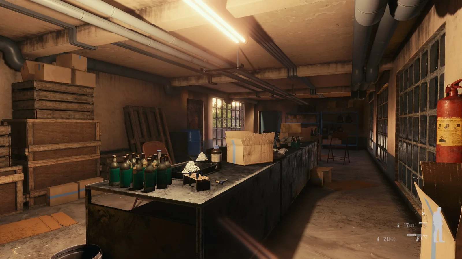 BLACKWOOD workroom with a long bench of green bottles and trays, crates, a fire extinguisher and glass-block windows